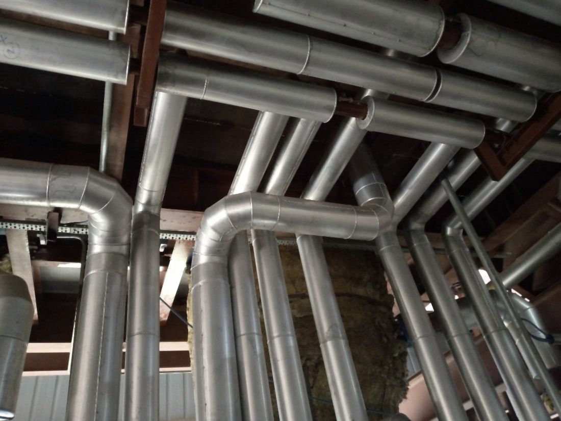 Overhead steam and condensate lines clad